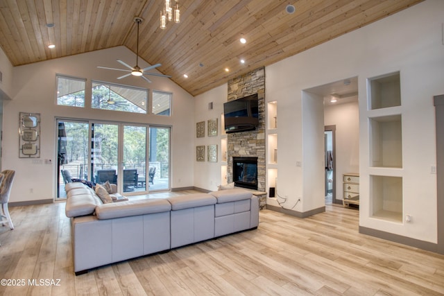 living area featuring high vaulted ceiling, a stone fireplace, wood ceiling, baseboards, and light wood-type flooring