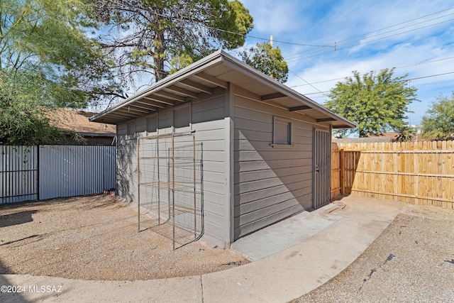 view of outbuilding featuring fence