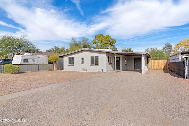 view of front of home with driveway and fence