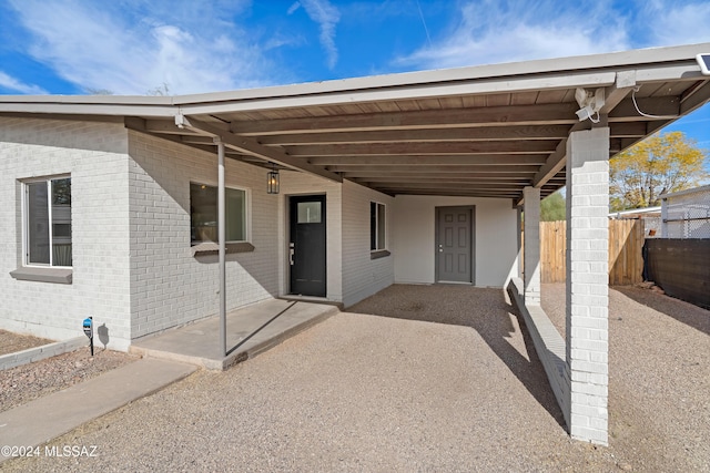 view of patio with fence and an attached carport