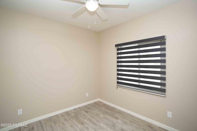 empty room featuring ceiling fan, wood finished floors, and baseboards
