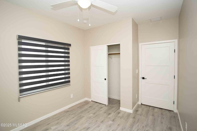 unfurnished bedroom featuring light wood-style floors, a closet, a ceiling fan, and baseboards
