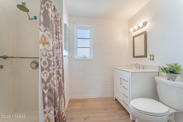 full bathroom featuring vanity, curtained shower, wood finished floors, and toilet