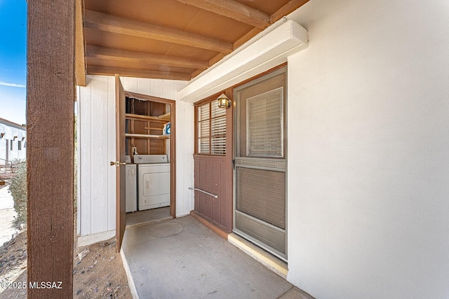 doorway to property featuring independent washer and dryer