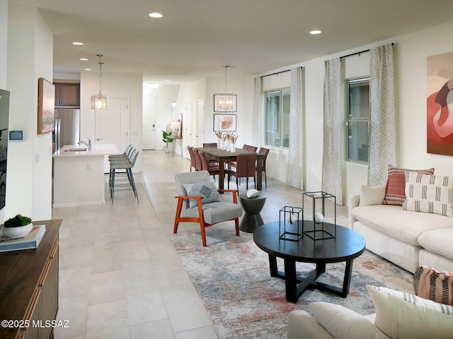 living room with light tile patterned floors, a notable chandelier, and recessed lighting