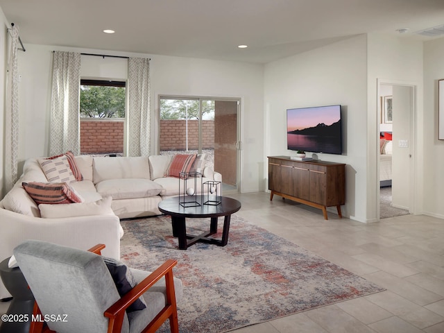 living area featuring baseboards, light tile patterned floors, visible vents, and recessed lighting