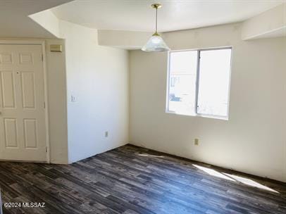 unfurnished room with wood finished floors