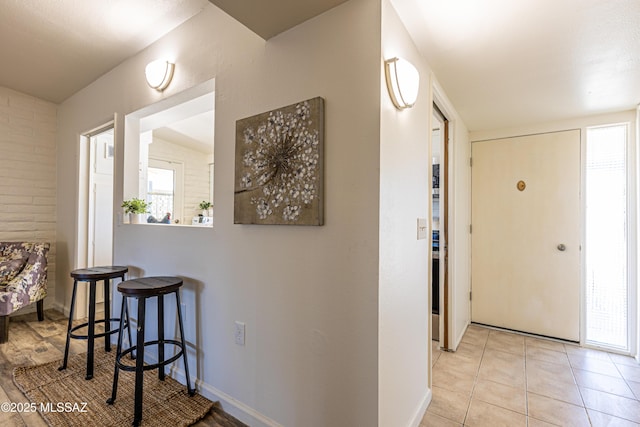 interior space featuring light tile patterned floors and baseboards