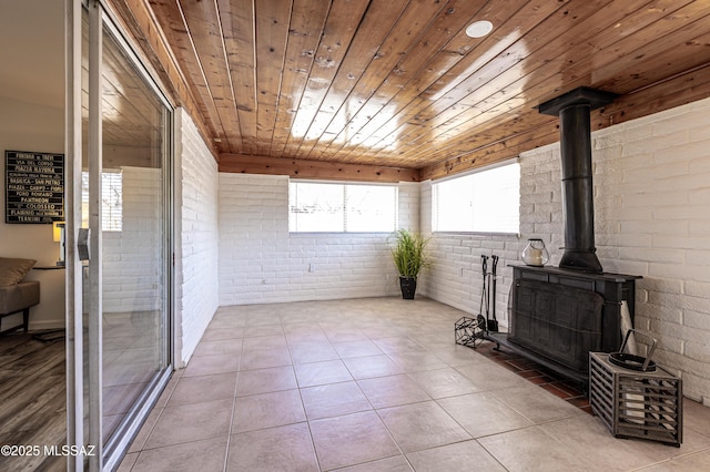 interior space featuring wooden ceiling and a wood stove