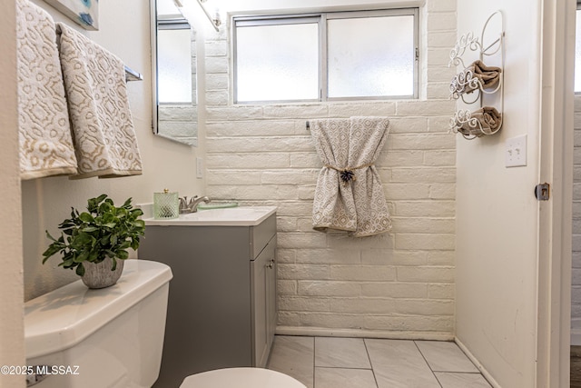 bathroom featuring vanity, tile patterned floors, toilet, and baseboards