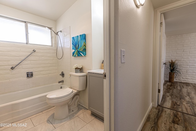 bathroom with vanity, wood finished floors, baseboards, tub / shower combination, and toilet