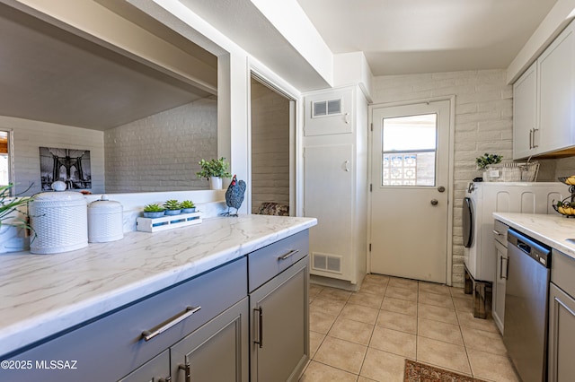 kitchen with dishwasher, gray cabinets, visible vents, and light tile patterned floors