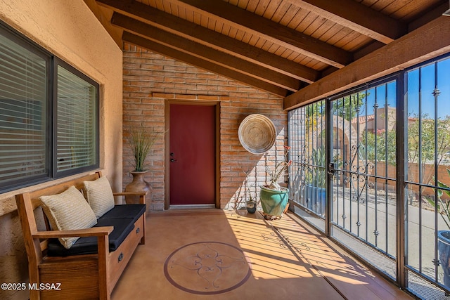 doorway to property featuring brick siding