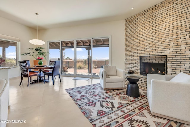 living area with a healthy amount of sunlight and a brick fireplace