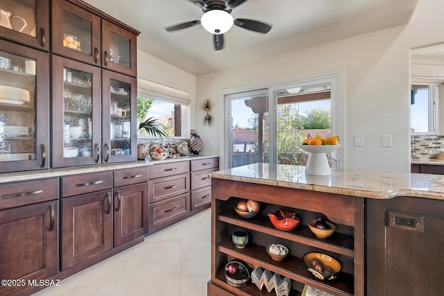 bar featuring a wealth of natural light, tasteful backsplash, ceiling fan, and light tile patterned flooring