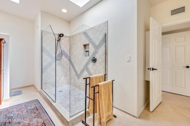 bathroom with visible vents, baseboards, and walk in shower