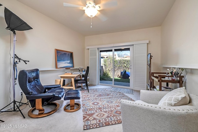 carpeted home office featuring a ceiling fan