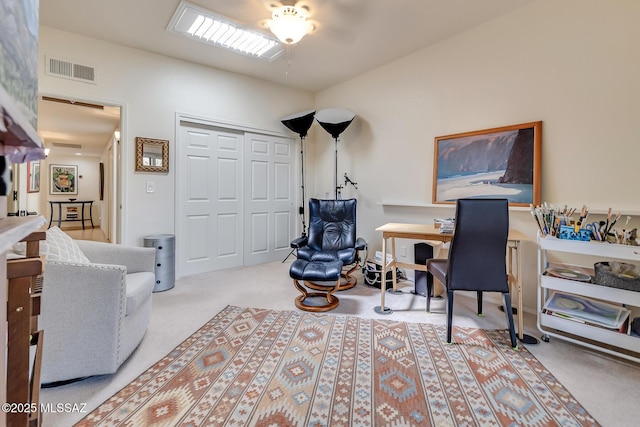 office area featuring visible vents and carpet flooring