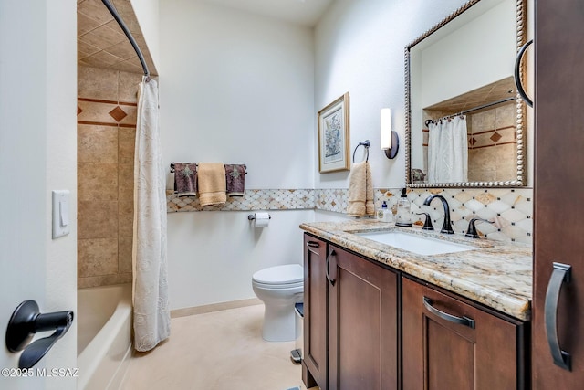 bathroom featuring decorative backsplash, toilet, and vanity