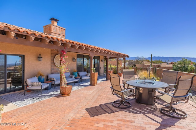 view of patio / terrace featuring a mountain view and outdoor dining space