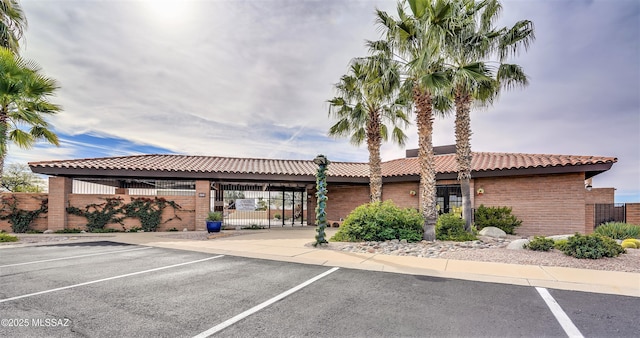 view of property featuring uncovered parking and fence