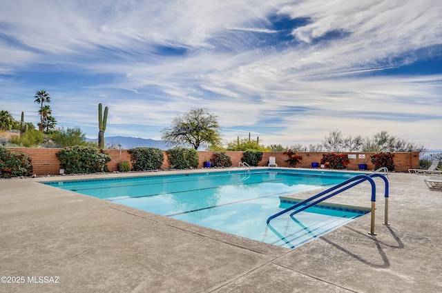 pool featuring a patio and a fenced backyard