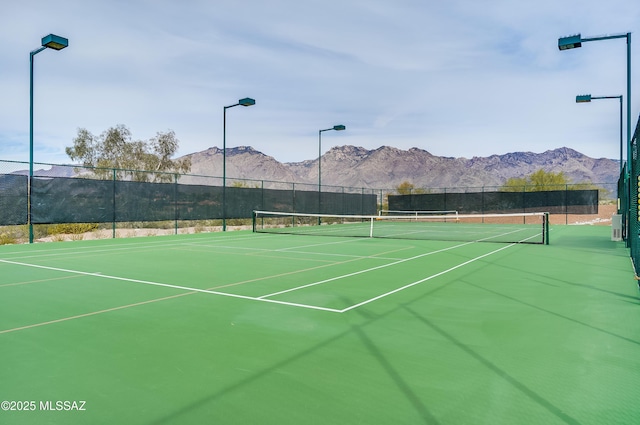 view of sport court with community basketball court, fence, and a mountain view