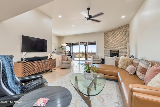 living room with recessed lighting, ceiling fan, and a fireplace