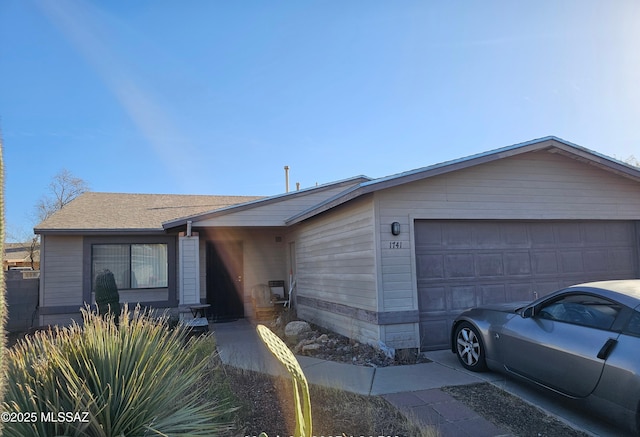 view of front of property with a shingled roof and an attached garage