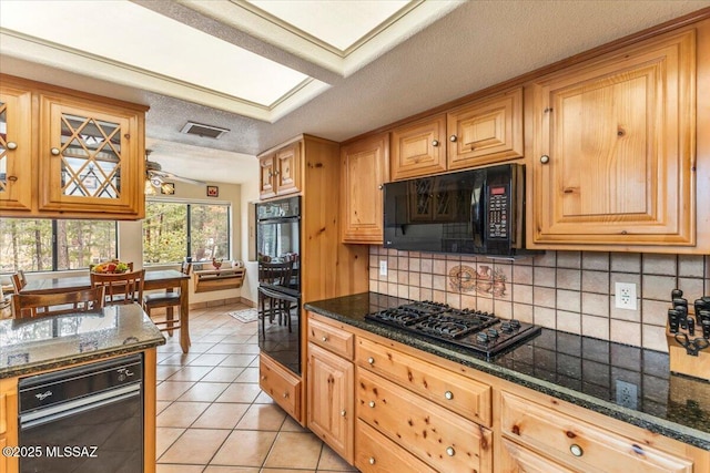 kitchen featuring light tile patterned floors, tasteful backsplash, visible vents, a textured ceiling, and black appliances