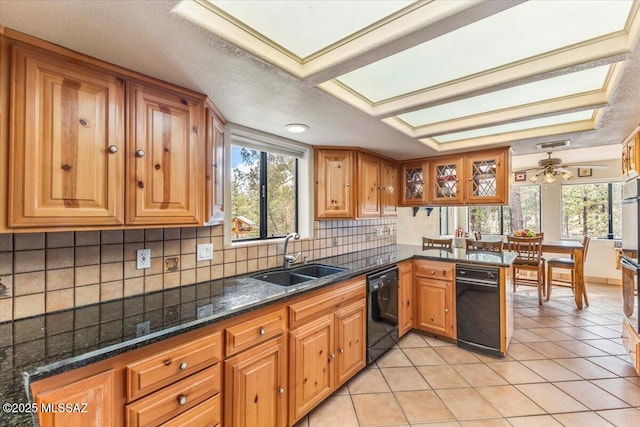 kitchen with black dishwasher, light tile patterned floors, plenty of natural light, and a sink