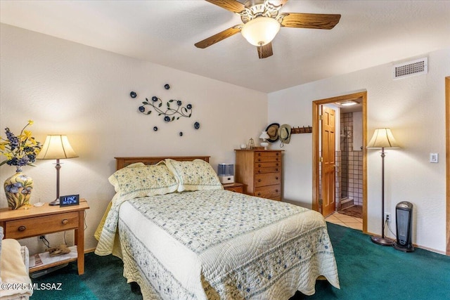 bedroom with carpet floors, visible vents, ceiling fan, ensuite bath, and baseboards