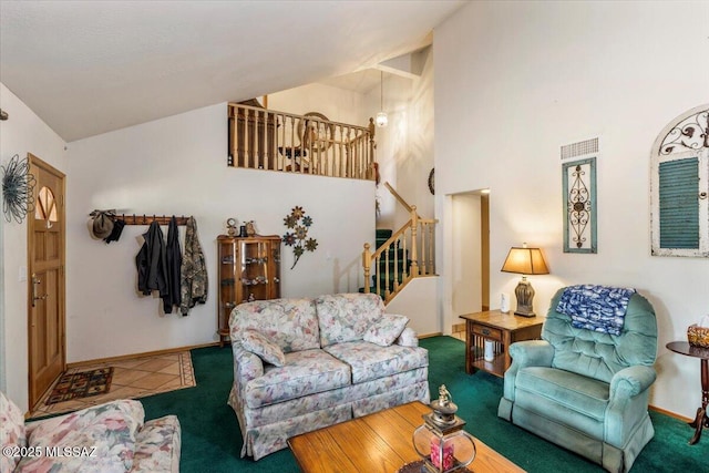 carpeted living area featuring high vaulted ceiling, stairway, and baseboards