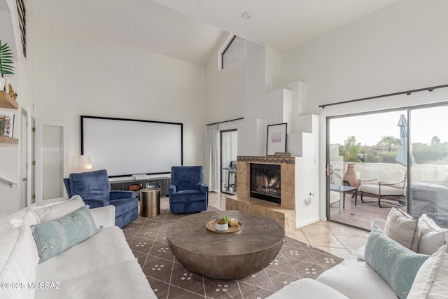 tiled home theater room featuring a fireplace and high vaulted ceiling