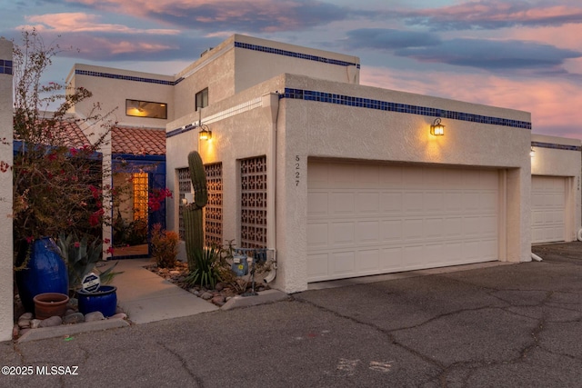 view of front of home with driveway and stucco siding