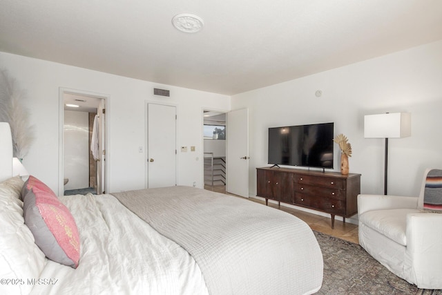 bedroom featuring visible vents and ensuite bathroom