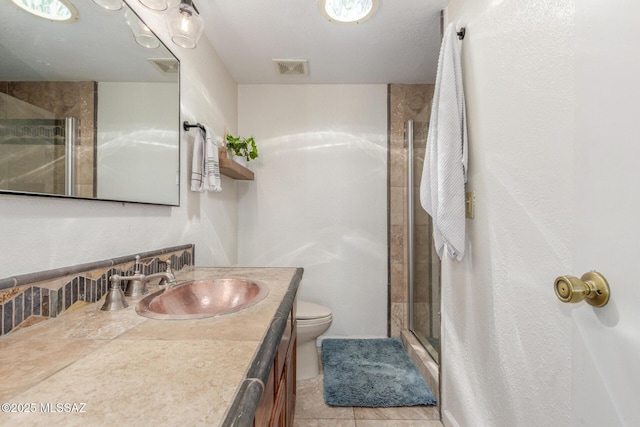 full bathroom with toilet, a stall shower, vanity, and visible vents