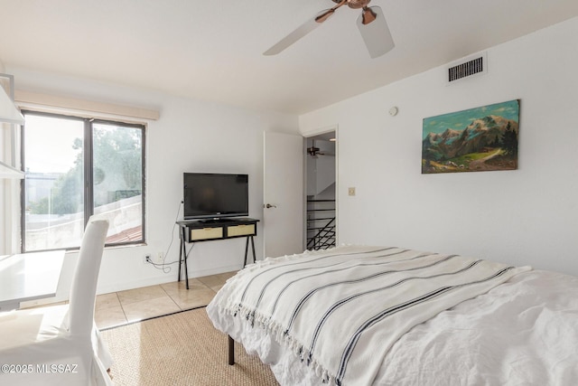 bedroom featuring visible vents, ceiling fan, baseboards, and tile patterned floors