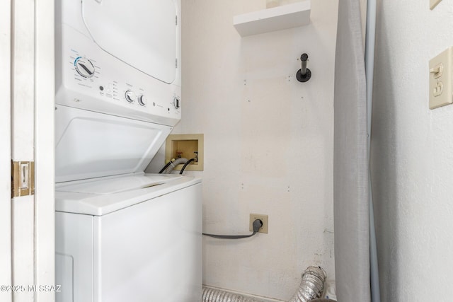 washroom with stacked washer and dryer and laundry area