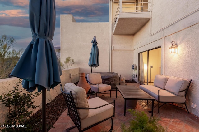 patio terrace at dusk featuring outdoor lounge area