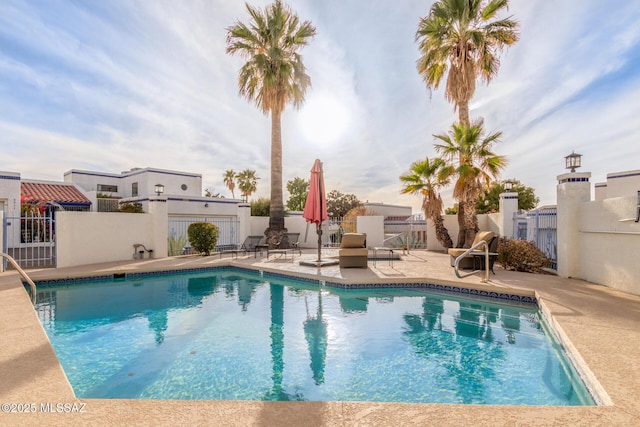 view of pool featuring a patio area, fence, and a fenced in pool