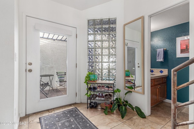 doorway to outside featuring tile patterned flooring