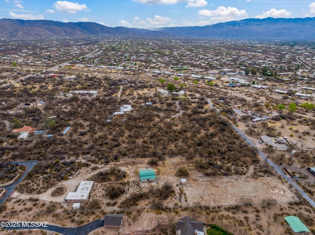 drone / aerial view with view of desert and a mountain view