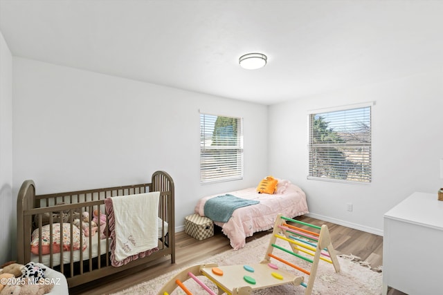 bedroom with wood finished floors and baseboards