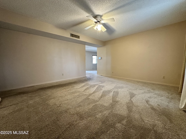 spare room with visible vents, carpet flooring, ceiling fan, a textured ceiling, and baseboards