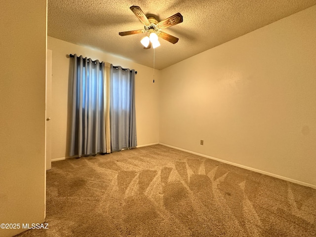 carpeted empty room with ceiling fan, a textured ceiling, and baseboards