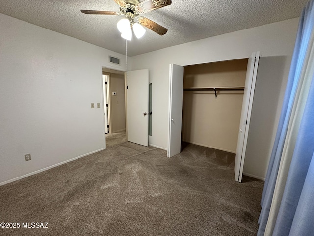 unfurnished bedroom with a textured ceiling, carpet floors, visible vents, baseboards, and a closet