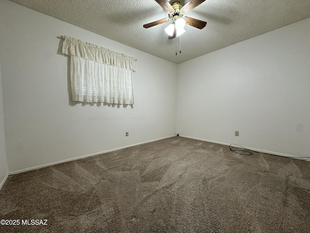 carpeted spare room featuring a ceiling fan, baseboards, and a textured ceiling