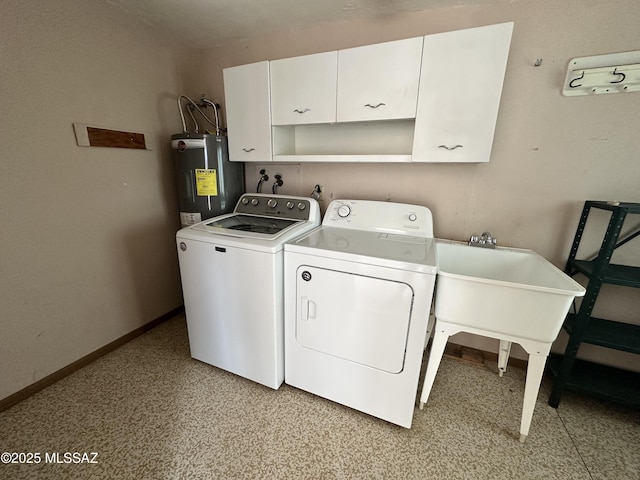 laundry area with cabinet space, washing machine and dryer, electric water heater, and baseboards