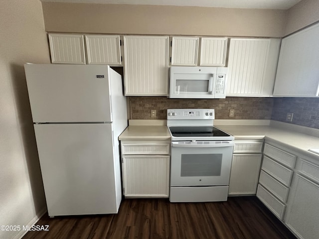 kitchen featuring dark wood-style floors, light countertops, white appliances, and decorative backsplash